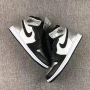 Top-down product view of the pair of black, white, and metallic silver high-top sneakers.