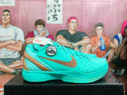 Side view of turquoise Nike basketball shoes with bronze-colored swoosh and heel accents