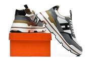Sneakers displayed beside an orange box, showing the side and heel details.