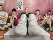 Front view of white lace-up basketball sneakers with padded tongues and sculpted toes