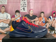 Side view of a navy basketball sneaker with red laces, yellow-orange heel detailing, contrasting Swoosh graphics, and a textured outsole.