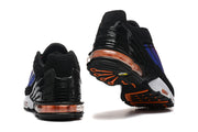 Rear and outsole views showing the black heel structure, orange-tinted cushioning, and orange outsole details.