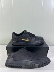 Black sneaker shown from the side and outsole, highlighting the textured upper and circular tread pattern.