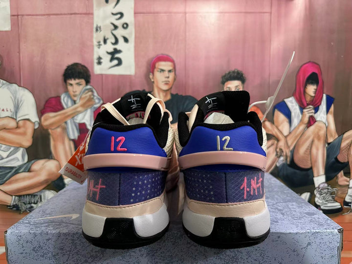 Rear view of pink, cream, purple, and blue Nike basketball shoes
