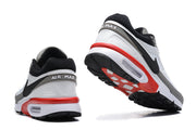 Rear and outsole views of Nike Air Max sneakers showing black and red sole details.