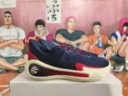Side view of a navy basketball shoe with red accents and a decorative logo panel
