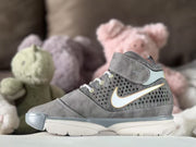 Side view of a gray high-top kids' sneaker with a patterned side panel, light swoosh-style detail and white outsole.