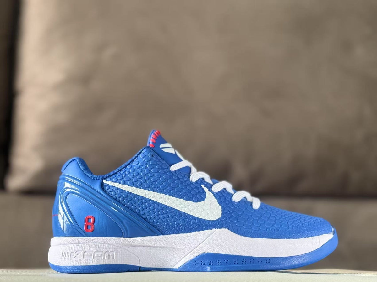 Side view of blue Nike Zoom Kobe 6 Protro sneakers with a white Swoosh, white midsole, blue outsole, and red number 8 heel detail.