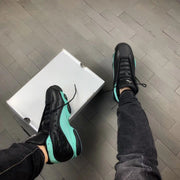 Top and side view of the sneakers beside a white shoe box