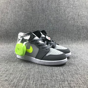 Pair of grey, charcoal and fluorescent volt mid-top sneakers shown from a front three-quarter angle.