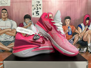 Angled view of magenta and white Nike basketball shoes