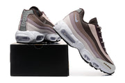 Nike sneakers displayed on a black box, showing layered side panels and Air units.