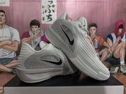 Gray Nike KD sneakers arranged together to show the side Swoosh details, raised upper texture, padded collars, and outsole pattern.