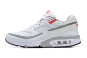 Side profile of a white Nike Air Max sneaker with grey trim and visible heel cushioning