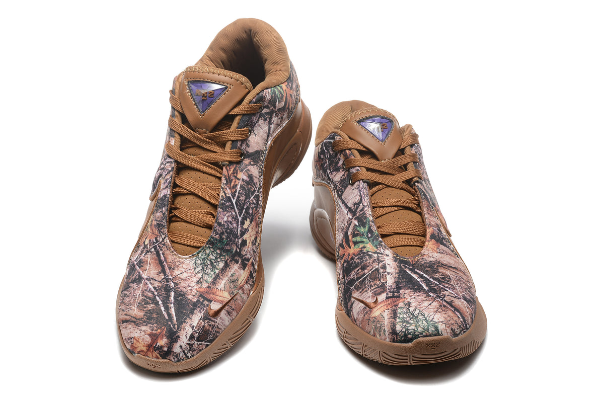 Pair of brown and woodland camouflage low-top sneakers shown from the front and side.