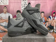 Gray and black high-top sneakers shown from an angled side view, highlighting the layered panels, lace eyelets, and padded collar.
