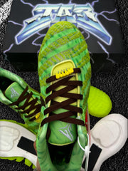 Close-up of the green mesh upper, dark laces, tongue, and sole components.