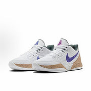 White Nike basketball sneakers with purple branding, gray panels, and speckled tan midsoles.
