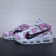 Pair of white and pink sneakers with oversized AIR lettering.
