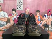 Front view of camouflage Nike basketball shoes with black laces, red tongue emblems, and textured patterned uppers.