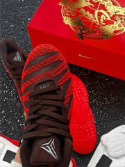 Top view of a brown and red basketball sneaker showing textured panels, dark laces and tongue branding.