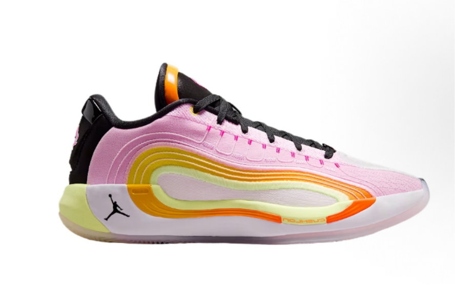 Side view of pink Jordan basketball sneakers with black laces, a layered yellow and orange side detail, and a visible Jordan logo near the heel.