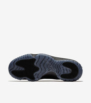 Studio outsole view showing black traction sections and a translucent blue-gray base.