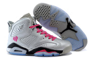 Pair of silver-gray high-top sneakers with pink accents, black midsole details, and a translucent outsole displayed underneath one shoe.