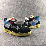 Pair of black Air Jordan 4-style sneakers with blue lining, white mesh panels, red accents, and yellow-toned soles.