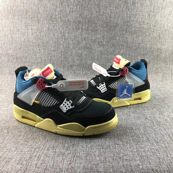 Pair of black Air Jordan 4-style sneakers with blue lining, white mesh panels, red accents, and yellow-toned soles.