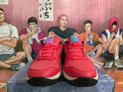 Front view of red Nike sneakers with mesh toe panels, red laces, blue tongue accents, and cream midsoles.