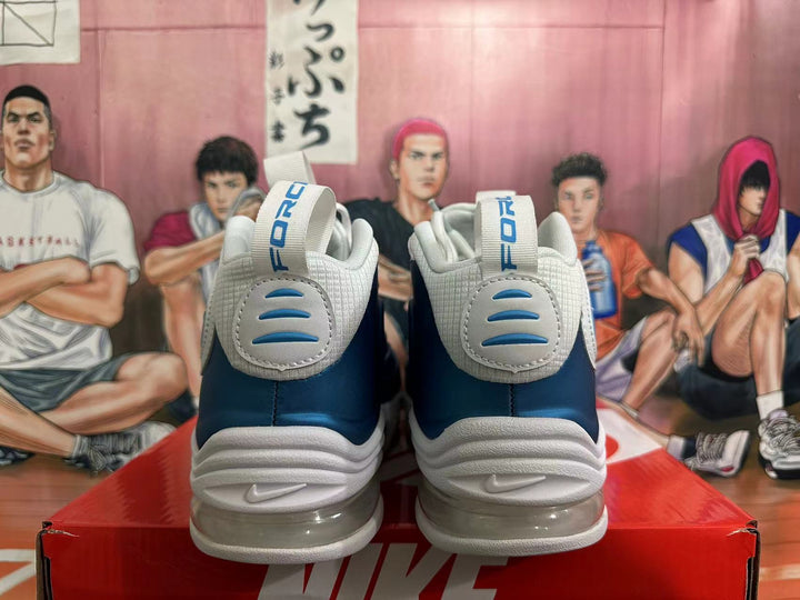Rear view of blue and white Nike sneakers showing heel details and sculpted midsoles.