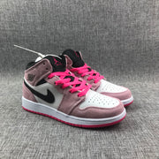 Pair of pink, white and black mid-top sneakers shown from a front three-quarter angle.