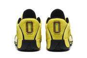 Rear view of the yellow and black sneakers showing the heel panels, black outsoles, and Jumpman heel branding.