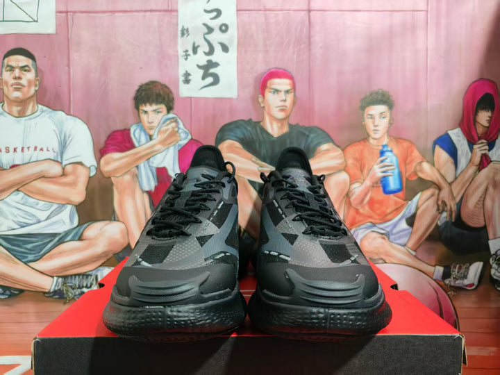 Front view of black Under Armour basketball sneakers displayed on a shoe box.