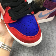 Close-up of the blue perforated toe box and red textured overlays on the high-top sneaker.