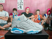 Side profile of a gray and blue high-top sneaker showing the Jordan Jumpman logo, perforated panels, layered upper, and sculpted sole.