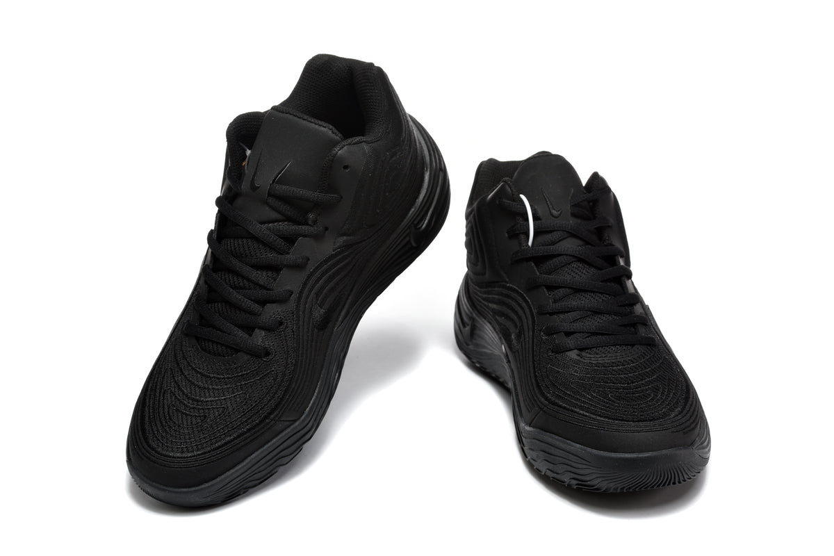 Pair of black Nike sneakers shown from a front three-quarter angle.