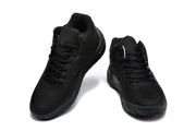 Pair of black Nike sneakers shown from a front three-quarter angle.