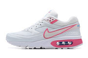 Side profile of a white Nike Air Max BW sneaker with pink accents and a visible heel cushioning window.