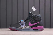 Side profile of one sneaker showing the dark grey upper, purple accents, and visible air-window area.