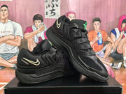 Angled view of black Nike KD 4 sneakers with green tongue accents and light-colored side Swooshes.