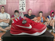 Side profile of a red Nike basketball sneaker showing the white swoosh and white outsole.