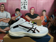Side view of a white ASICS basketball shoe with black detailing and rust-red tongue