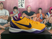 Side view of a yellow Nike basketball shoe with purple Swoosh and heel details