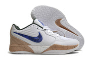 White Nike Ja 2 shoe with blue side logo and tan speckled accents beside patterned outsole