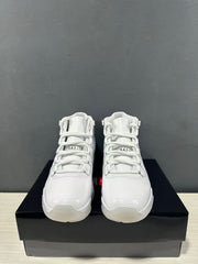 Front view of a pair of white high-top sneakers with tonal laces and padded tongues.