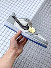 Side view of the sneaker with a patterned black Swoosh and a gold-tone decorative hangtag.