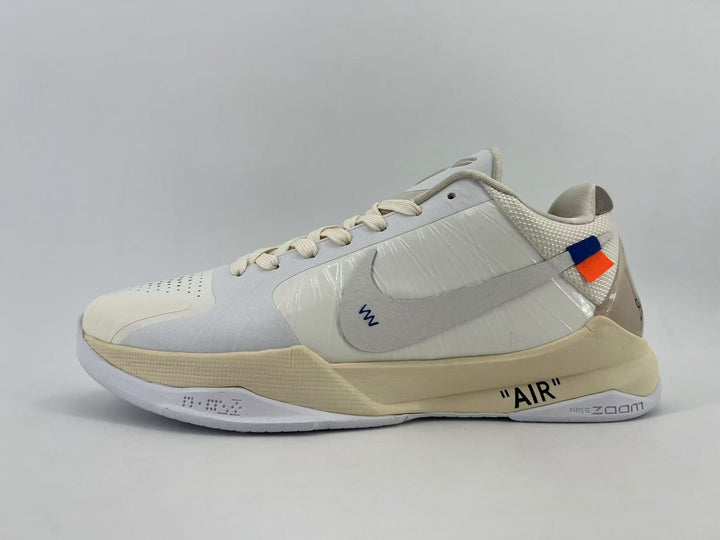 Side view of light-colored Nike low-top sneakers with a contrasting Swoosh and “AIR” lettering on the midsole.