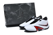 Pair of white, black, and red basketball shoes beside a dark shoe box